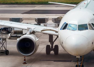 Unloading suitcases from the plane at the airport.