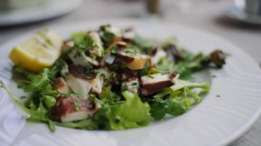 Traditional salad with octopus and herbs.