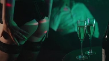 Man and stripper dancer in strip club.