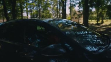 Woman in car passing by.