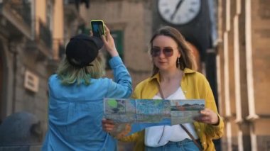 Woman and her daughter exploring old city.