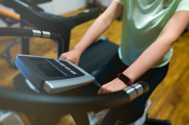 Woman jogging on treadmill at the home gym.