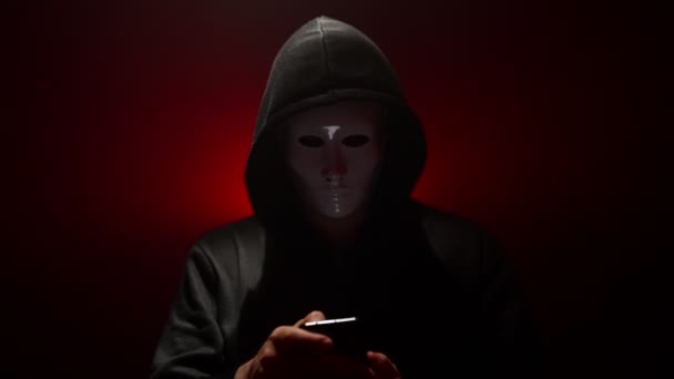 Man Met Masker Met Hoodie Lanceert Virus Vanaf Smartphone — Stockvideo