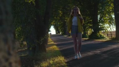 Woman tourist with backpack walking in the countryside.