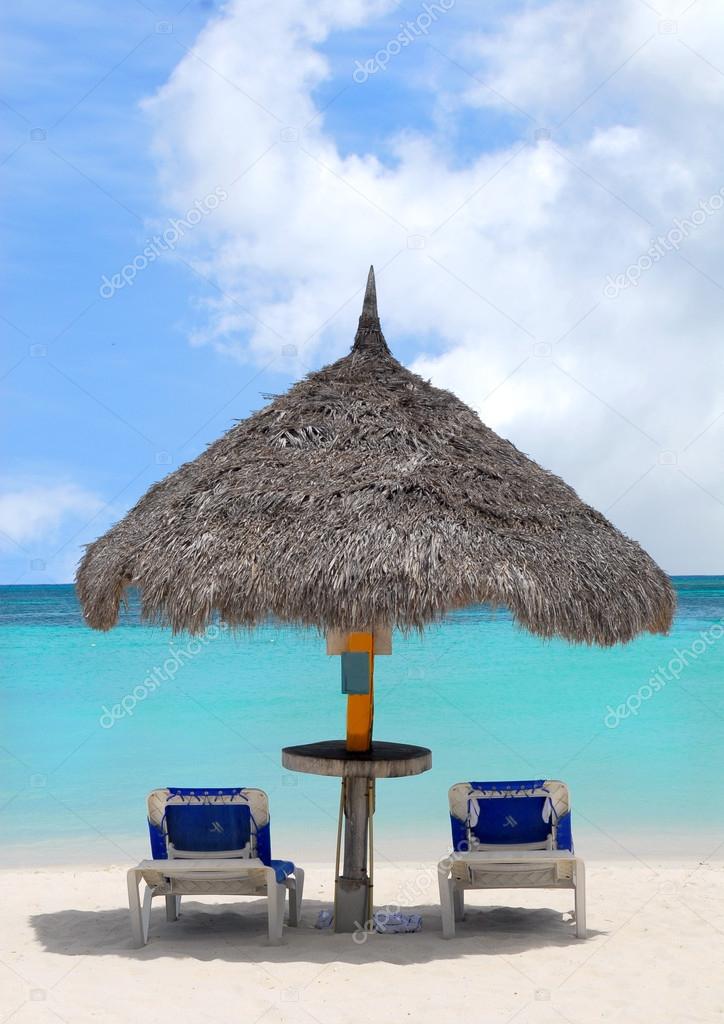 Thatched hut on a white sand beach in Aruba
