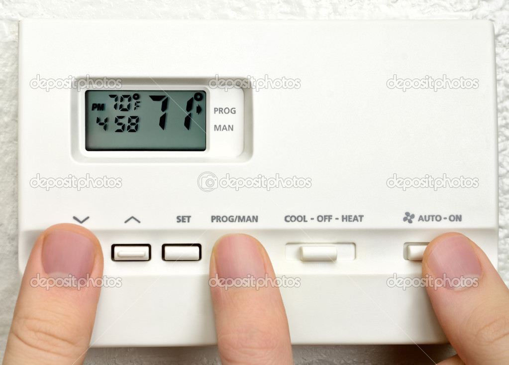 Three persons adjust thermostat