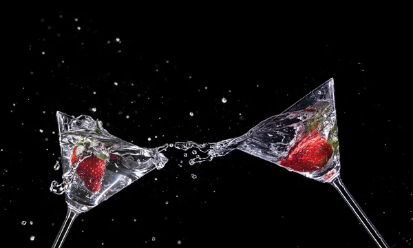 View of martini glass with strawberry on black background Stock Photo