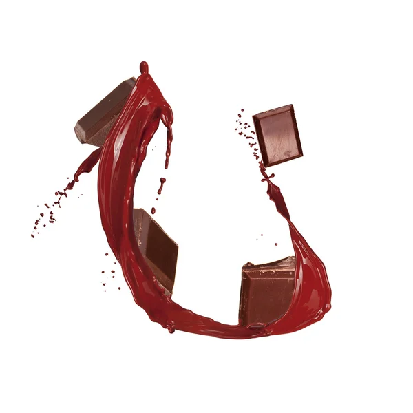 Chocolate splash with pieces of bar — Stock Photo, Image
