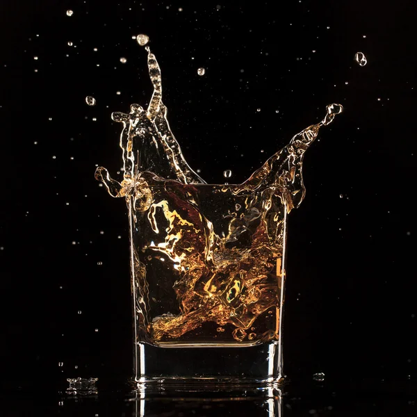 Splashing whiskey — Stock Photo, Image