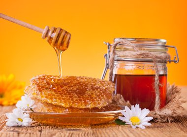 Honey in jar with honeycomb and wooden drizzler clipart