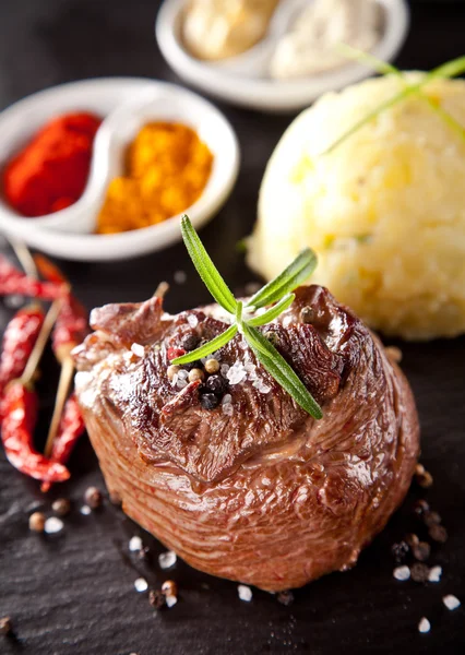 Fresh beef steak on black stone — Stock Photo, Image