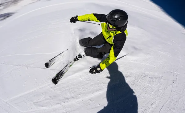 Alpine skier on piste, skiing downhill — Stock Photo, Image