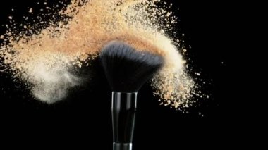 Patlayan bej tozuyla çok yavaş makyaj fırçası. Yüksek hızlı sinema kamerası, 1000fps.