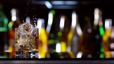 Buz küpünün viski içkisine dönüşmesi çok yavaş bir hareket, kamera hareketi. Hız rampası etkisi. Yüksek hızlı sinema kamerası, 1000 fps..