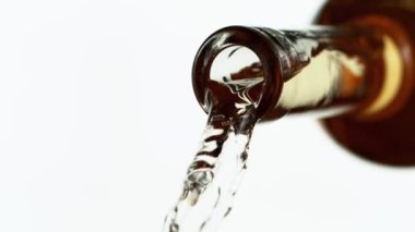 Beyaz arka planda izole edilmiş beyaz şarabın çok yavaş bir şekilde dökülmesi. Hız rampası etkisi. Yüksek hızlı sinema kamerası, 1000 fps.