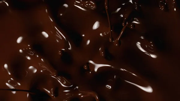 Closeup Splashing Dark Melted Chocolate Top View — Stock Photo, Image