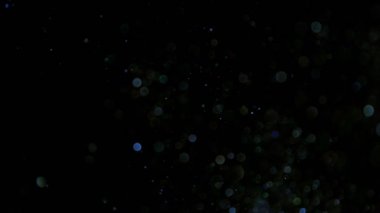 Siyah arkaplanda ışıldayan mavi parçacıkların süper yavaş çekimi. Sığ odak derinliği. Yüksek hızlı sinema kamerası, 1000 fps..