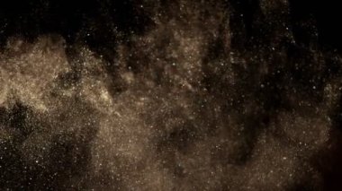 Siyah zemin üzerinde ışıldayan altın parçacıkların süper yavaş çekimi. Sığ odak derinliği. Yüksek hızlı sinema kamerası, 1000 fps..