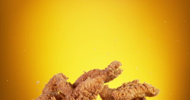 Super Slow Motion Flying Fried Chicken Pieces Golden Background Filmed — 图库视频影像