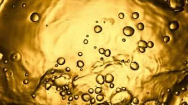 Super slow motion of bubbling whiskey, cognac or oil surface. Filmed on high speed cinema camera, 1000 fps.