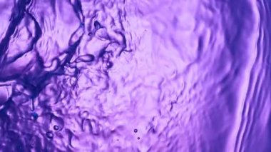 Super slow motion of splashing colored water waves. Filmed on high speed cinema camera, 1000 fps.