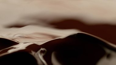 Detail of splashing melted chocolate. Macro shot, food background.