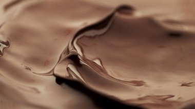 Detail of splashing melted chocolate. Macro shot, food background.