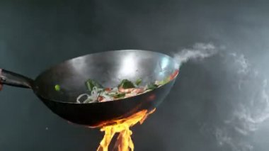 Tavadan sebzeli Asya eriştesi süper yavaş çekimde. Yüksek hızlı sinema kamerası, 1000 fps. Hız rampası etkisi.