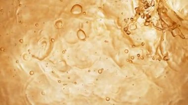 Altın sıvı sıçrayan süper yavaş hareket. Yüksek hızlı sinema kamera, 1000 fps filme.