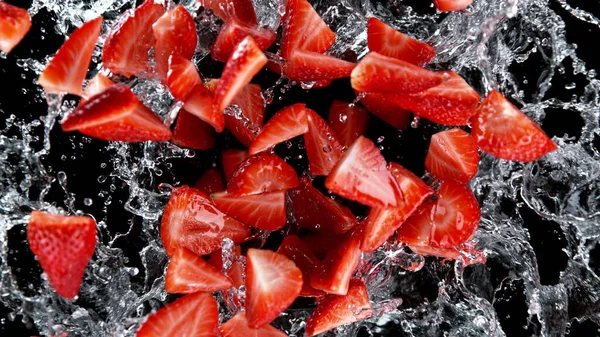 Freeze Motion Sliced Strawberries Water Splash Isolated Black Background — Stock Photo, Image