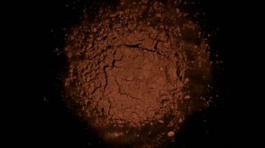 Siyah arka planda kahve tozu dönüşünün süper yavaş çekimi. Yüksek hızlı sinema kamerası, 1000fps.