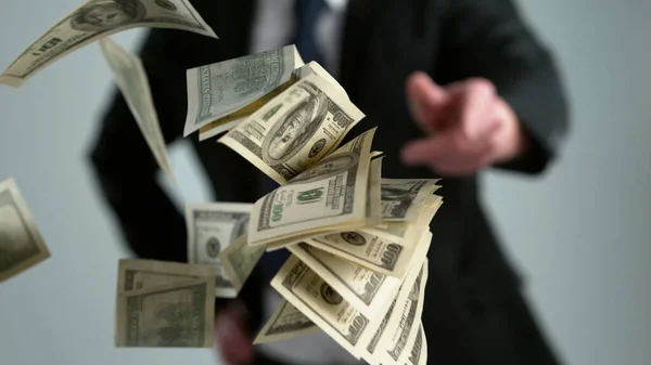 Close Young Businessman Throwing Out Money Banknotes Isolated Gray Background — Stock Photo, Image