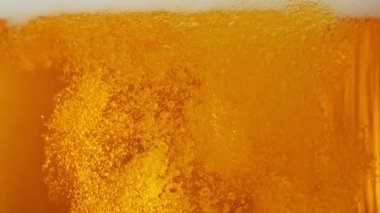 Süper yavaş çekimde makro bardakta bira, yakın çekim. Yüksek hızlı sinema kamerası, 1000 fps. Kamera hareket halinde.