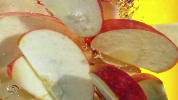 Super Slow Motion Rotating Sliced Red Apples Pieces Underwater Filmed — Stock videók