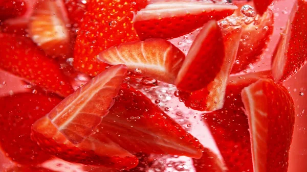 Close Strawberries Slices Water Isolated Red Background — Stock Fotó