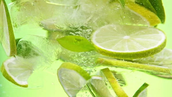Close Lime Slices Water Isolated Yellow Background — Stockfoto