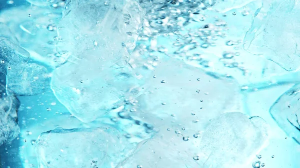 Close Ice Cubes Underwater Blue Background Freeze Motion Flowing Ice — Zdjęcie stockowe