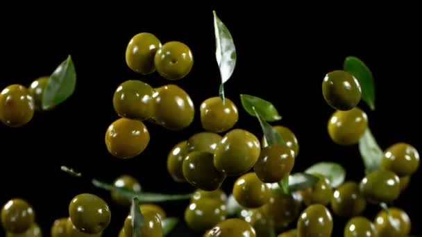 Super Slow Motion Flying Green Olives Black Background Filmed High — стоковое видео