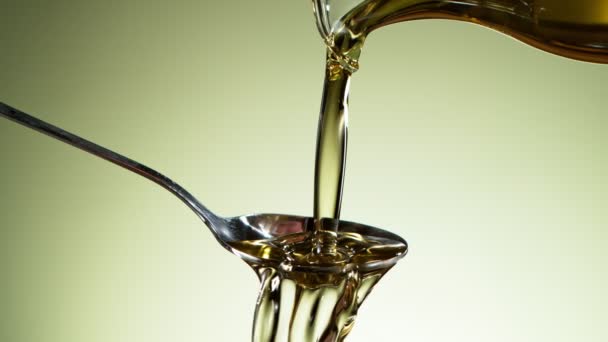 Super Slow Motion Pouring Oil Metal Spoon Filmed High Speed — Stock Video