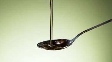 Super slow motion of pouring oil on metal spoon. Filmed on high speed cinema camera, 1000fps.