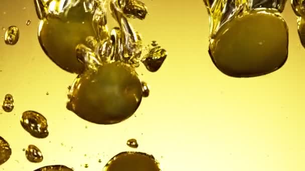 Super Slow Motion Falling Green Olives Oil Filmed High Speed — стоковое видео