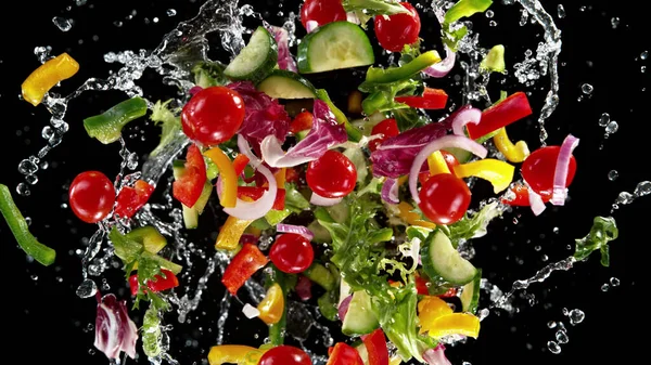 Freeze Motion Flying Salad Splashing Water Isolated Black Background — Stock Photo, Image