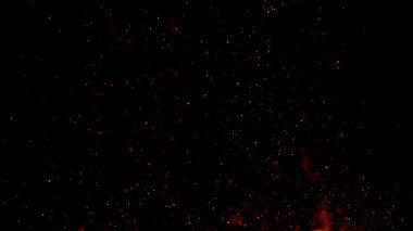 Ateş siyah zemin üzerinde parçacıklar gibi uçuşan kıvılcımlar. Soyut arkaplan.