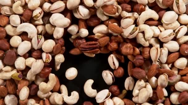 Super Slow Motion Blowing Mix Nuts Black Background Filmed High — Stock Video