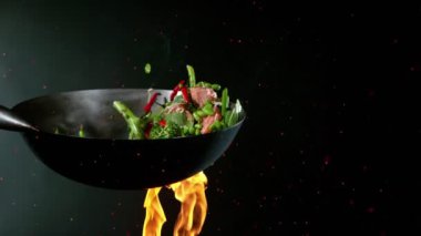 Süper yavaş uçan somon eti ve tavadan Asya sebzesi. Yüksek hızlı sinema kamerası, 1000 fps..