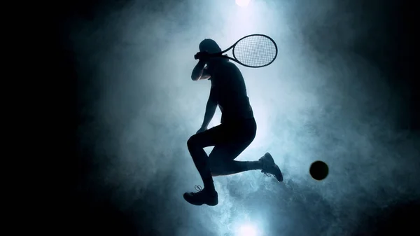 戏剧化的网球选手轮廓在空中跳跃 背景上有烟熏的轮廓 黑暗的壁纸场景 艺术感 — 图库照片