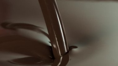 Super Slow Motion of Pouring Dark Melted Chocolate. Filmed with High Speed Cinema Camera, 1000fps. Speed Ramp Effect.