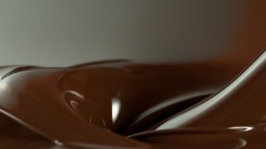 Super Slow Motion of Pouring Dark Melted Chocolate. Filmed with High Speed Cinema Camera, 1000fps. Speed Ramp Effect.