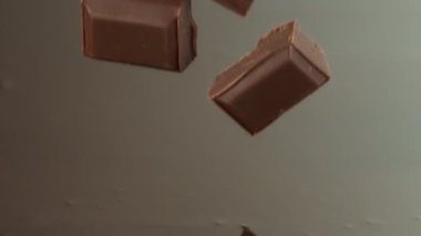 Super Slow Motion of Falling Chocolate Pieces into Melted Chocolate. Filmed with High Speed Cinema Camera, 1000fps.
