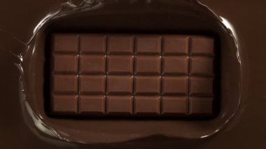 Super Slow Motion of Falling Chocolate Bar into Melted Chocolate. Filmed with High Speed Cinema Camera, 1000fps.